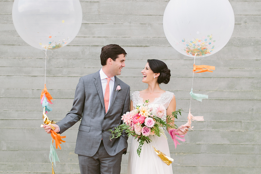 Bride and groom fun wedding day portrait with giant balloons and streamers at Trinity River Audubon Cetner in Dallas