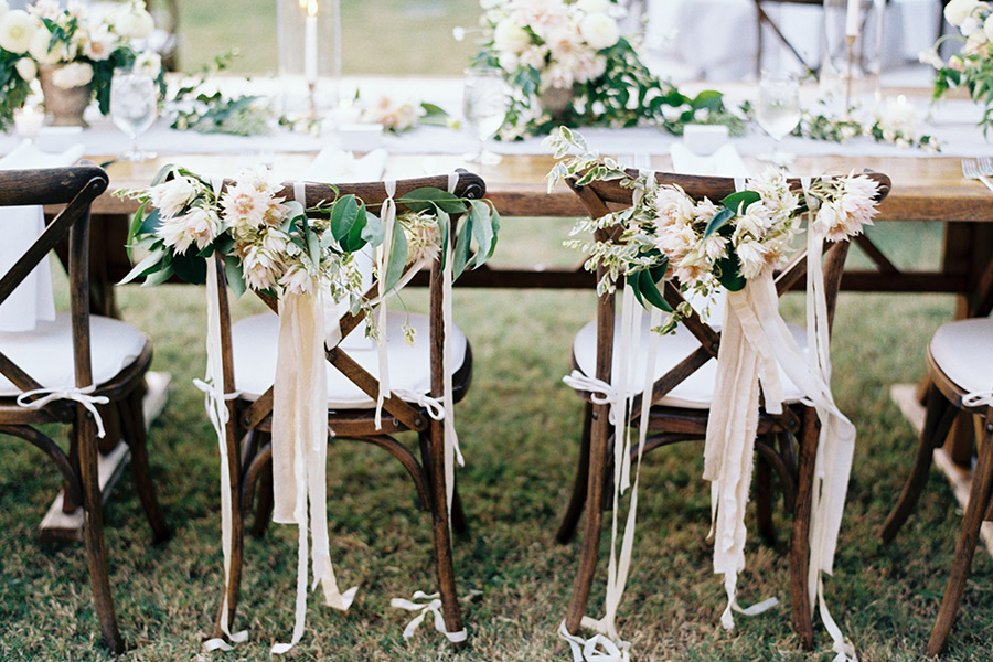 Crosback wedding chairs with floral garland and streamers