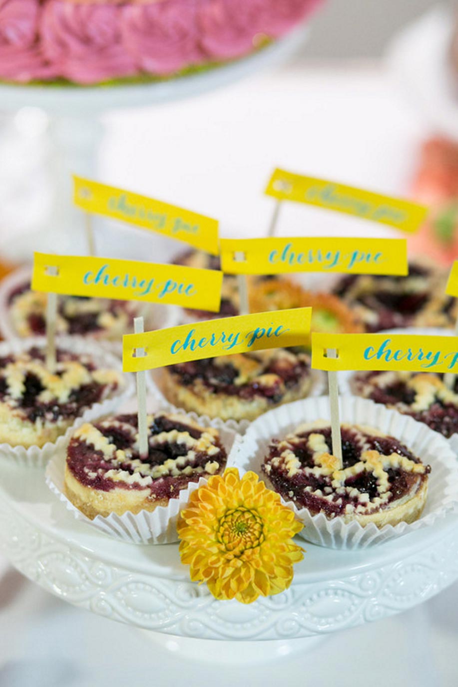 Mini cherry pies with calligraphy topper flags for wedding reception dessert