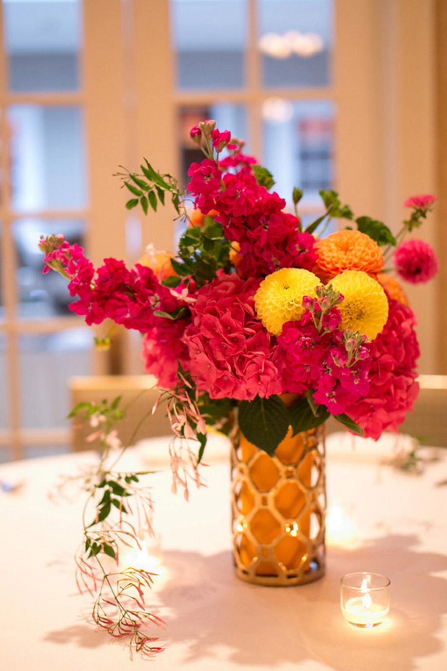 Pink hydrangea, orange and yellow Dahlia wedding centerpiece