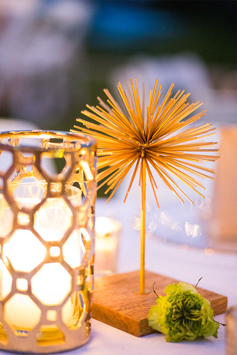 Gold starburst and candle wedding centerpiece
