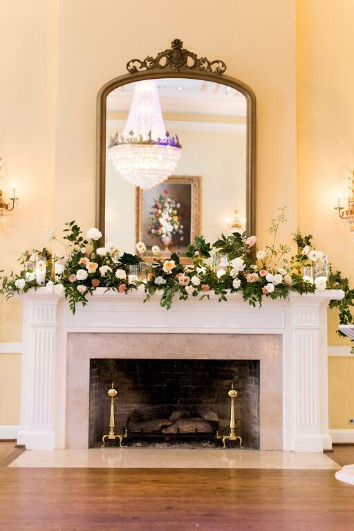 Arlington Hall fireplace mantle covered in greenery and blooms