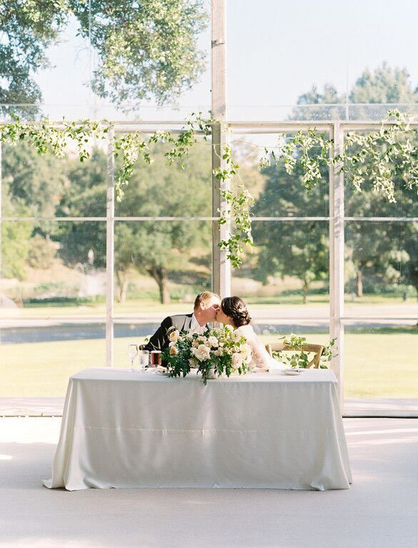 Bride and groom at rectangle sweetheart table