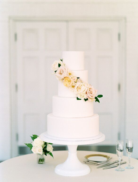 4 tier faux wedding cake with peach and blush blooms