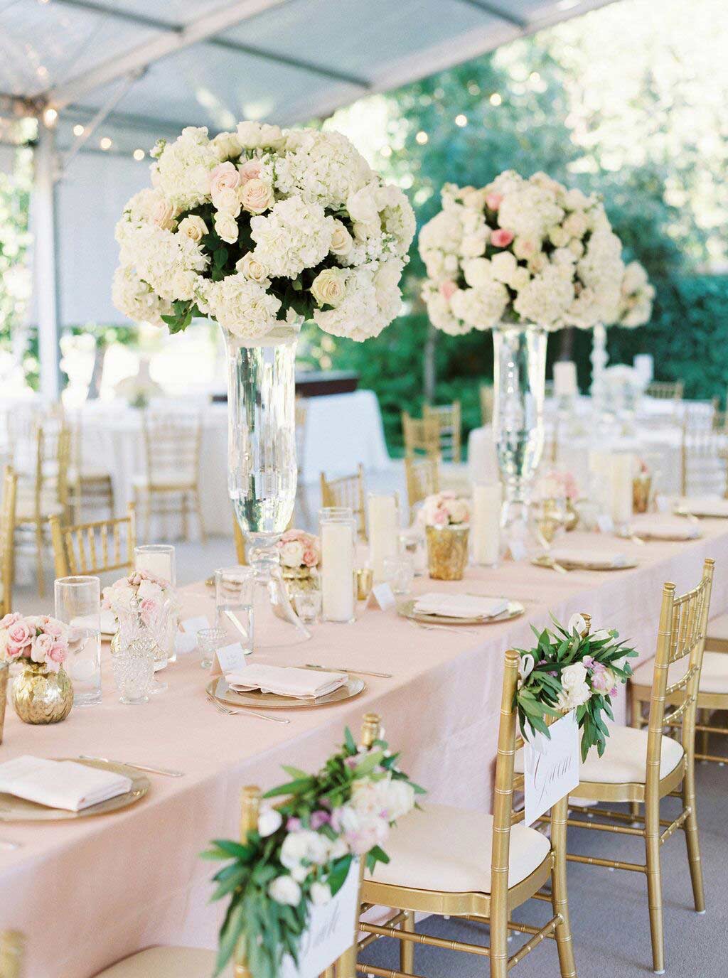 Wedding head table with clear tall vase centerpieces