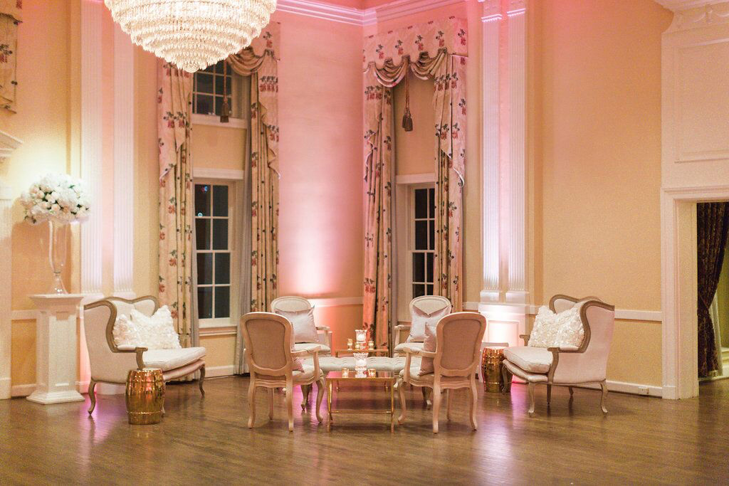Lounge seating and pink uplighting at Arlington Hall reception