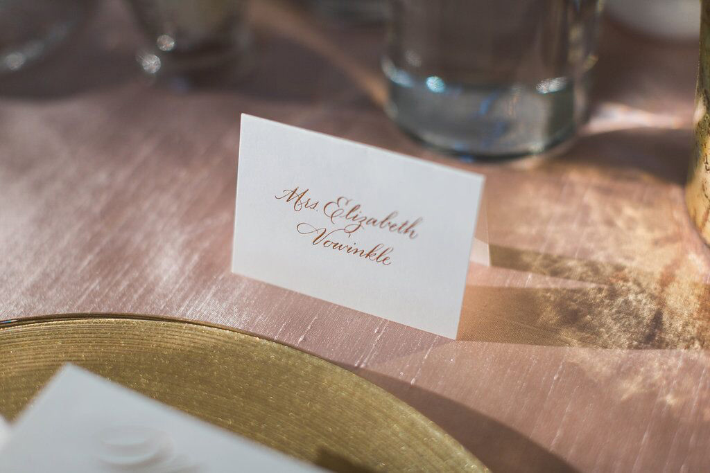 Gold calligraphy wedding place card