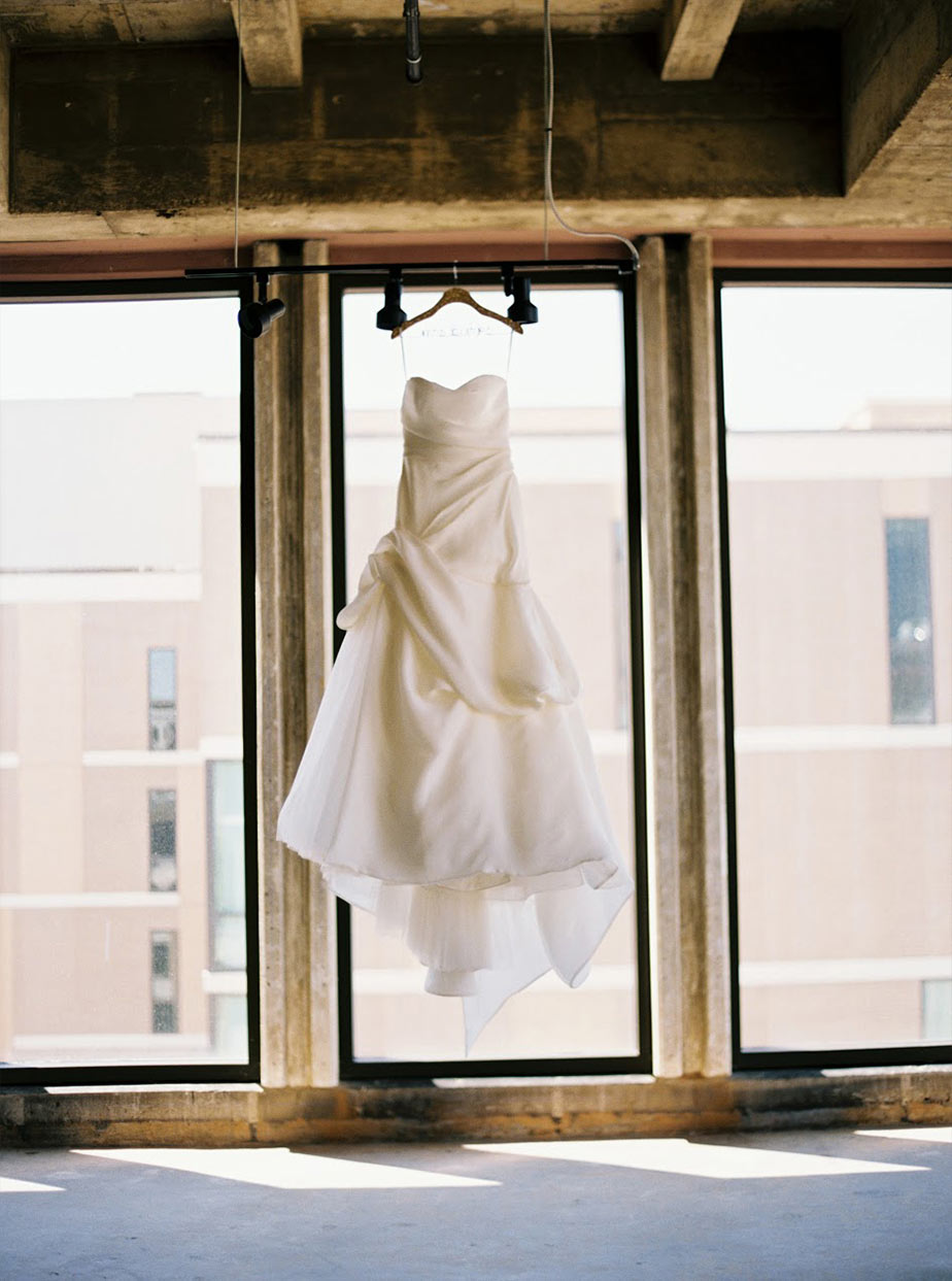 Wedding dress hanging in a window