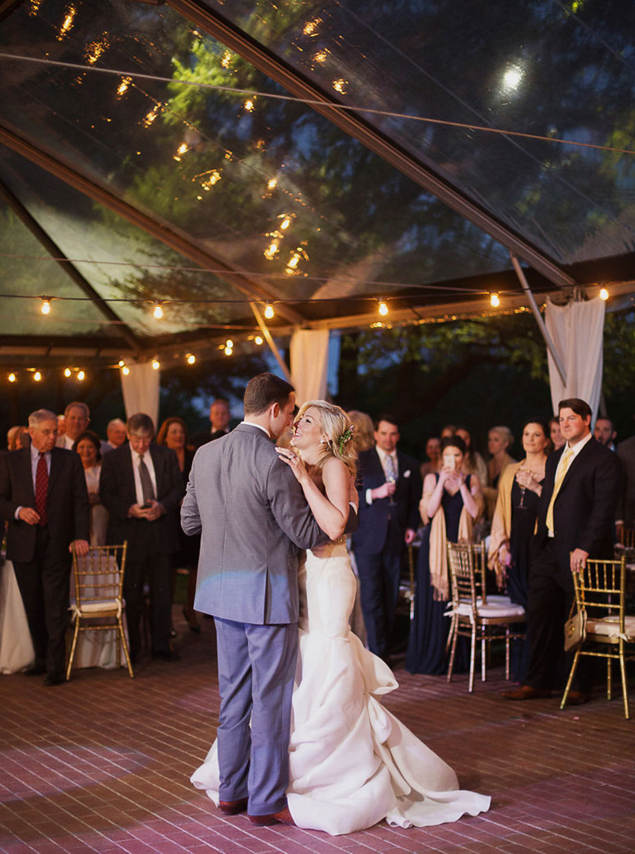 Bride and groom first dance under clear tent