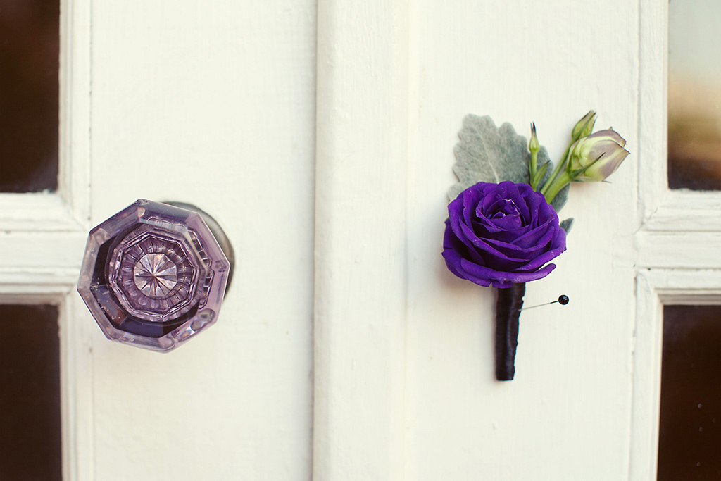 purple boutonniere on door knob