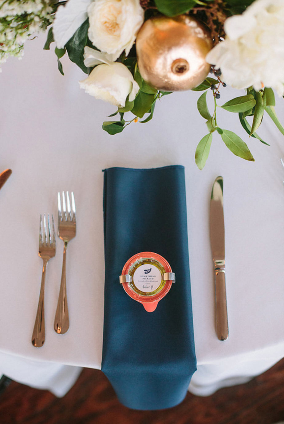 Wedding place setting, navy hanging napkin with favor on top