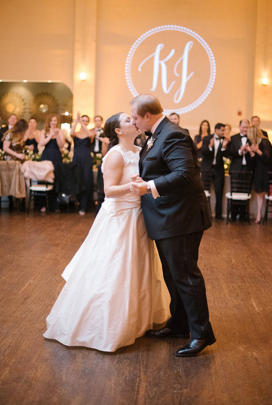Bride and groom first dance at The Room on Main in Dallas with white gobo monogram