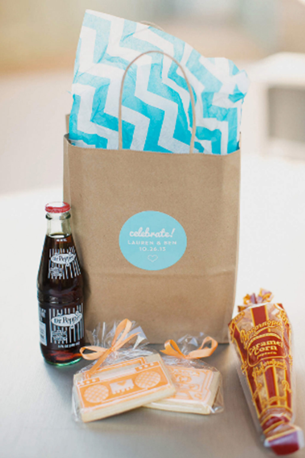 Dr. Pepper, popcorn, and tape cassette cookies in wedding out of town welcome hotel bag