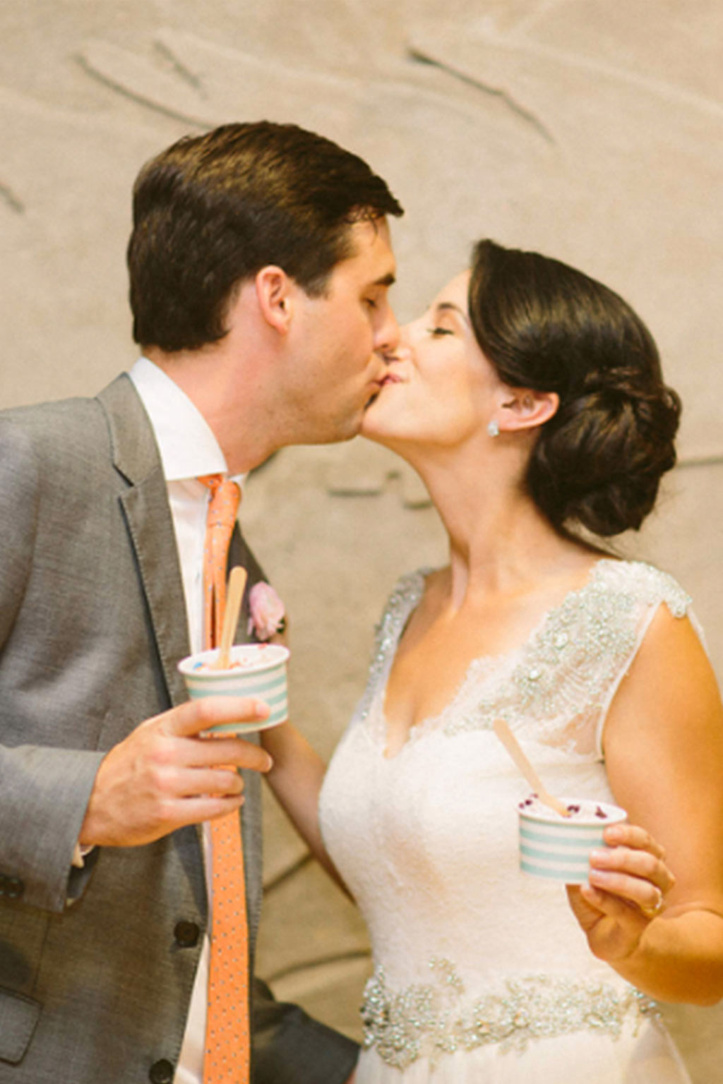 Bride and groom kiss with Carnival Barkers ice cream cups