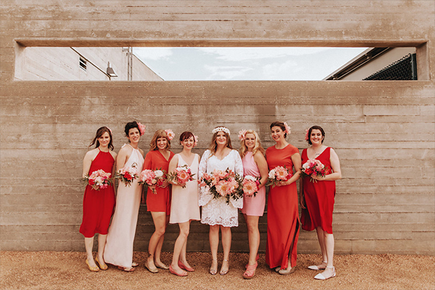 Mix-match bridal party in reds and pinks at the Trinity River Audubon Center in Dallas