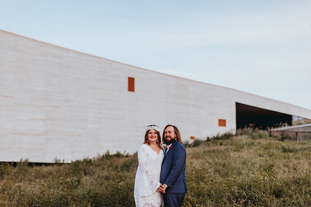 Bride and groom take a wedding day portrait in front of the Trinity River Audubon Center in Dallas