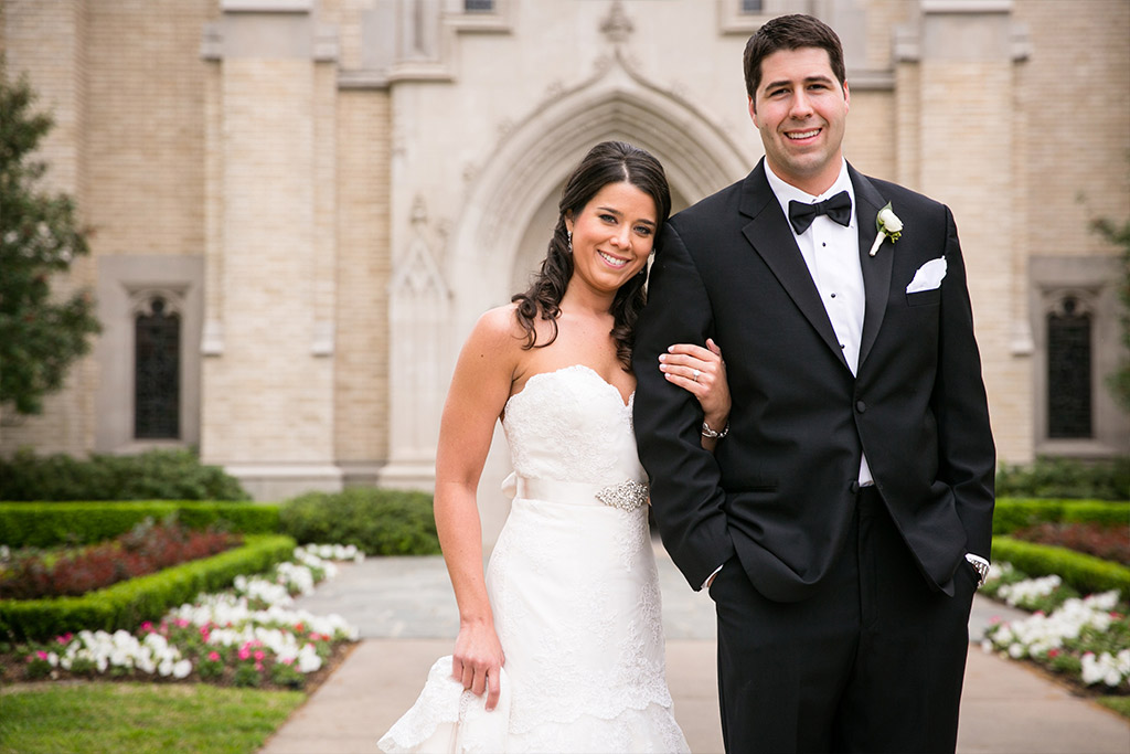 Bride and groom take a wedding day portrait in frontHighland Park Presbyterian Church in Dallas