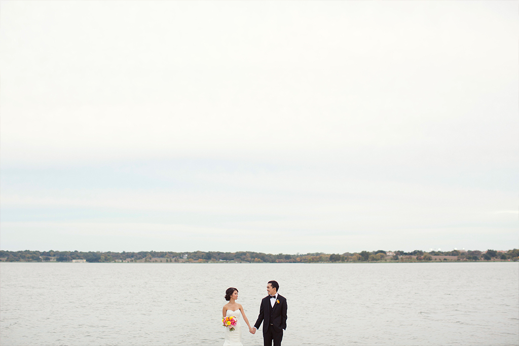 Bride and groom take a wedding day portrait in front of a Texas Lake