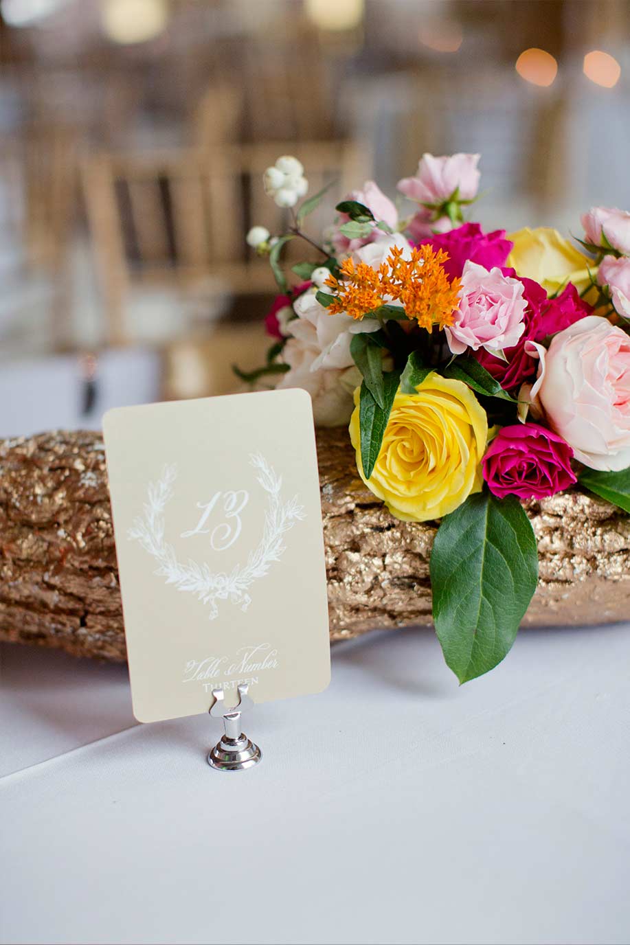 Gold log wedding centerpiece and laurel wreath table number