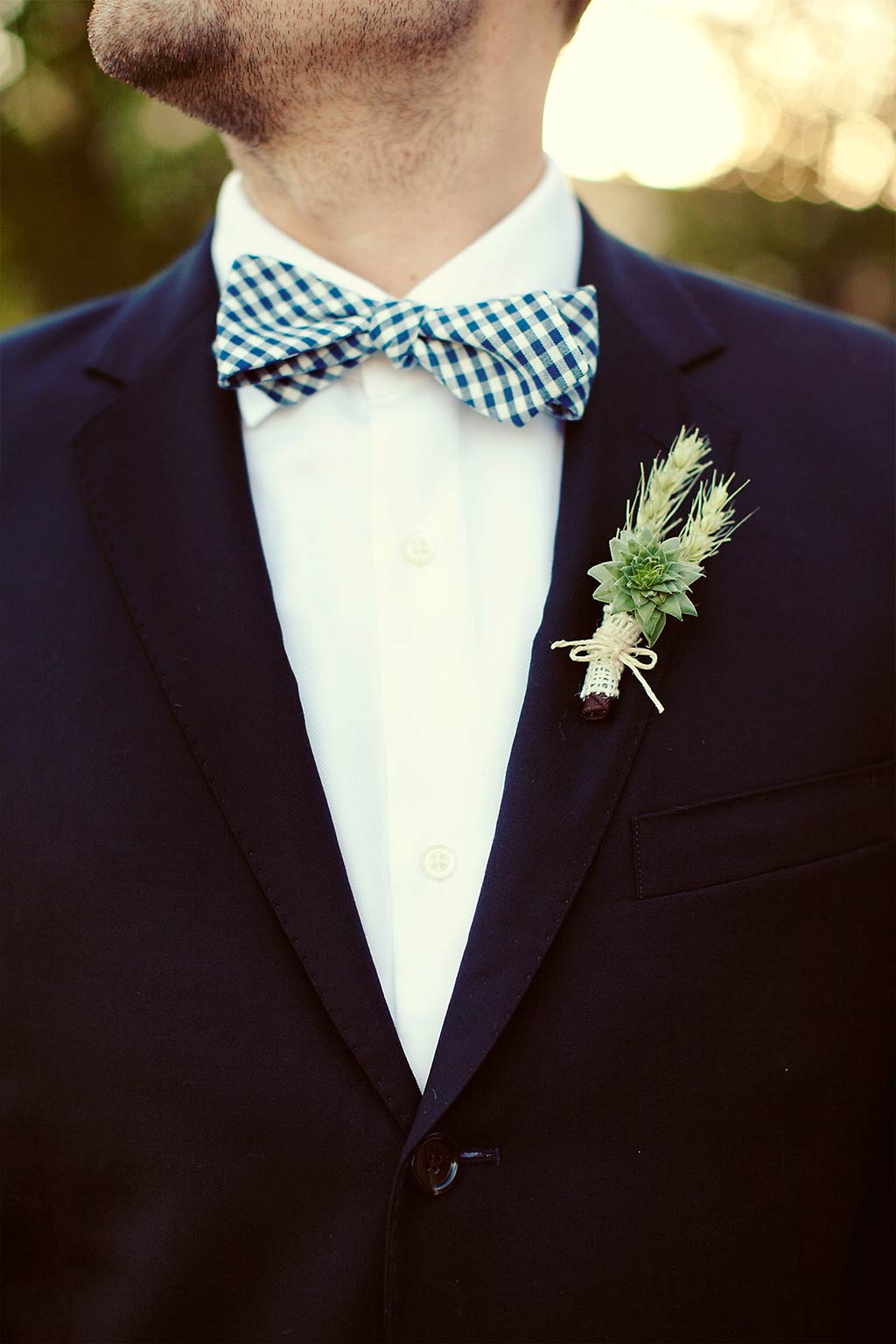 succulent and wheat grooms boutonniere with checkered bowtie