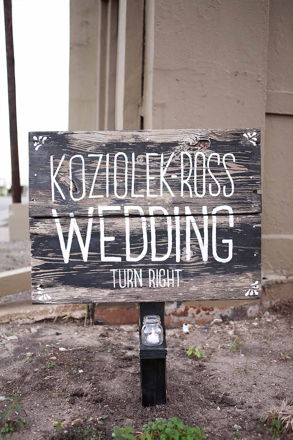 worn wood hand painted wedding sign with votive candle