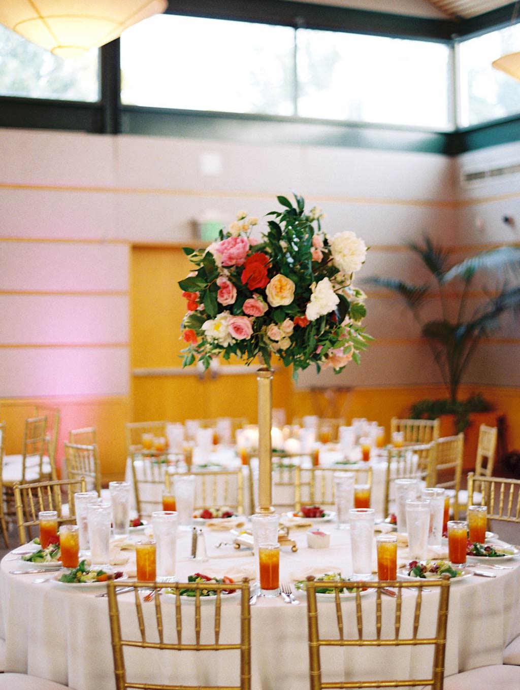 Tall round table centerpiece at wedding reception at Rosine Hall at The Dallas Arboretum
