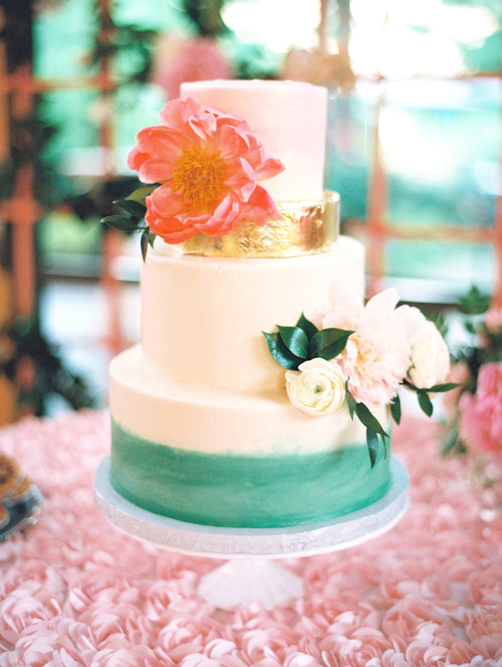 Watercolor bridal wedding cake with metallic gold layer and fresh flowers