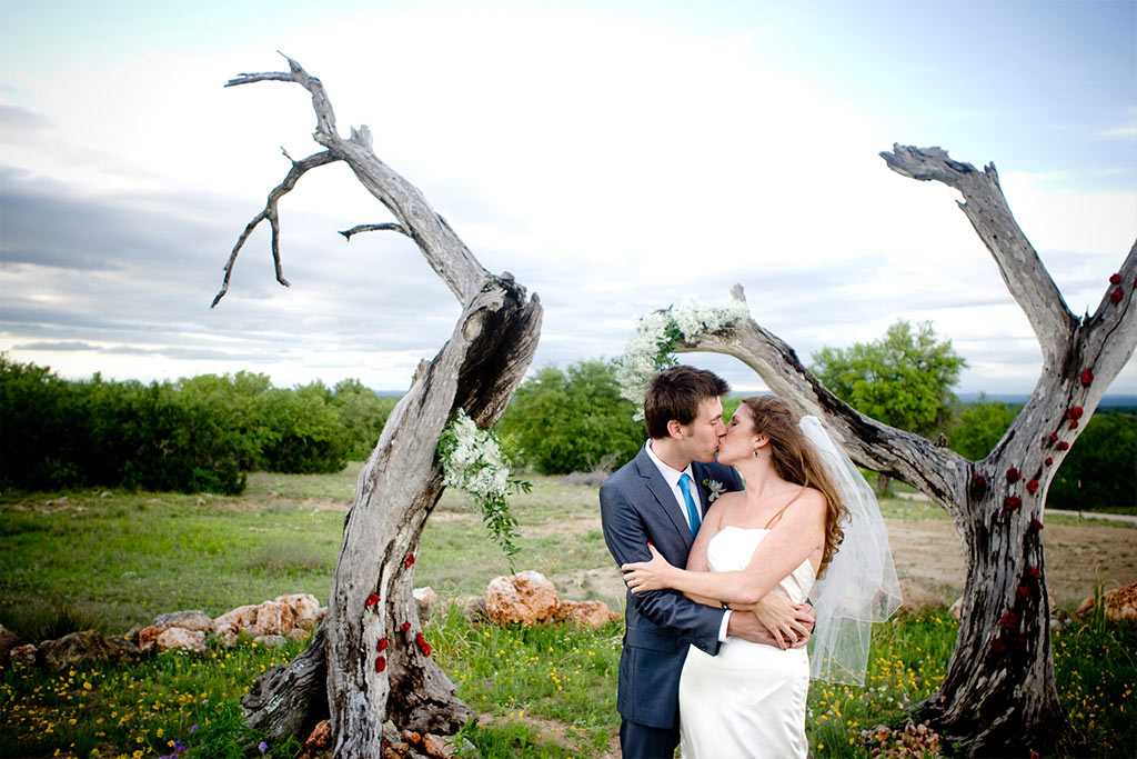 Bride and groom wedding day portrait with Texas wildflowers in Hill Country near Austin