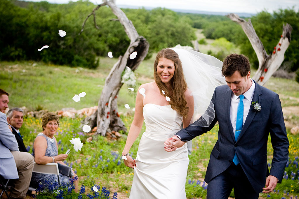 throwing pedals after Texas Hill country wedding ceremony