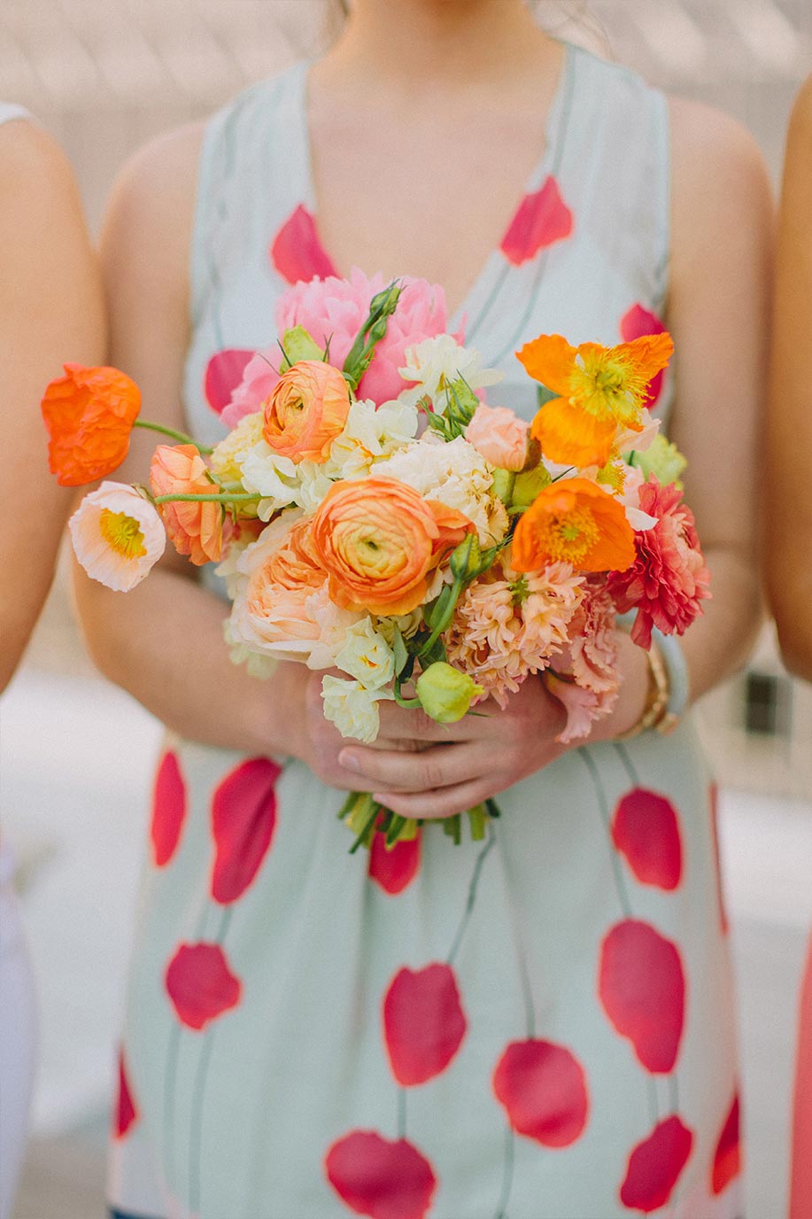 Bridesmaid with pink and orange bouquet and mix and match dress