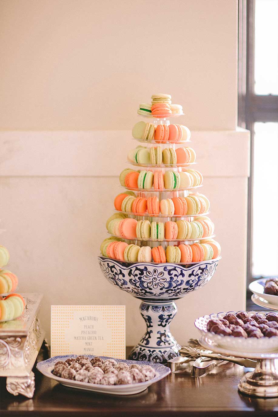 Wedding dessert table with macaroons and chocolate truffles on blue and white porcelain