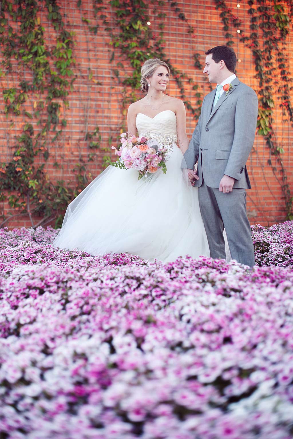Bridge and groom portrait over purple flower field at Hickory Street Annex in Dallas