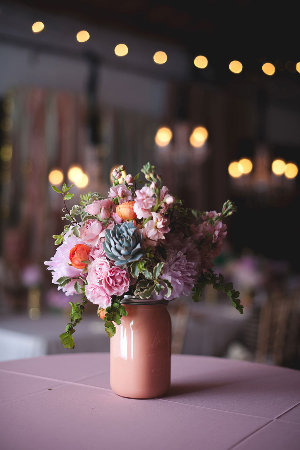 Wedding floral arrangement in peach mason jar