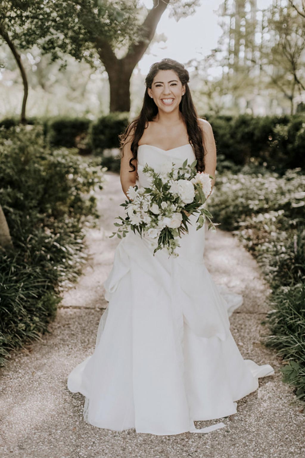 Wedding day garden bridal portrait with white and green natural bouquet and Madison by Monique Lhuillier sleeveless wedding dress