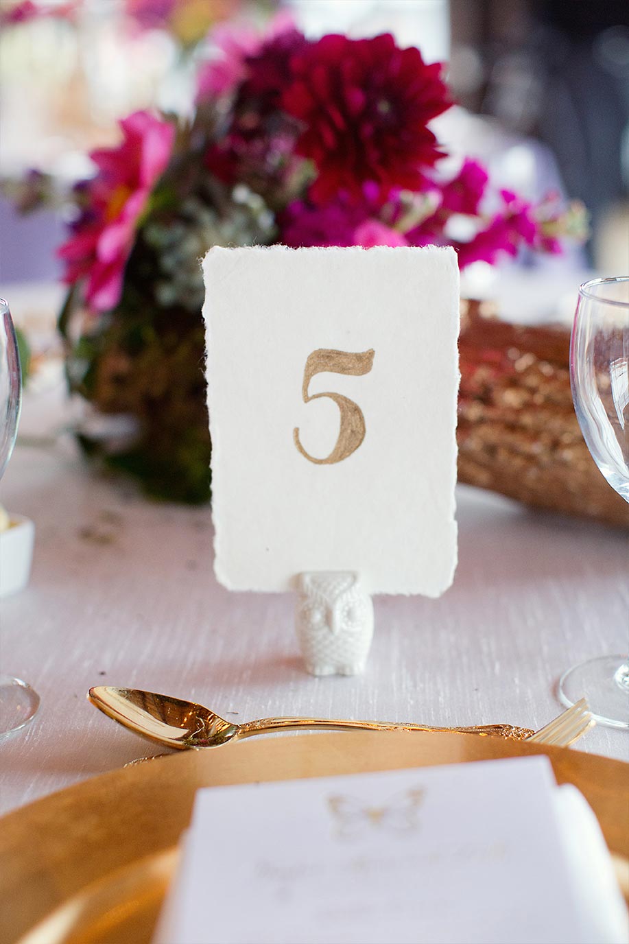 Gold calligraphy table number on deckle edge paper