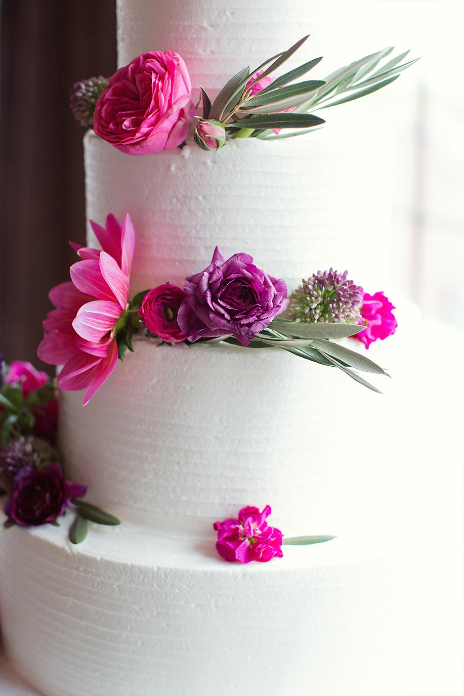 Brides cake with pink and purple flowers