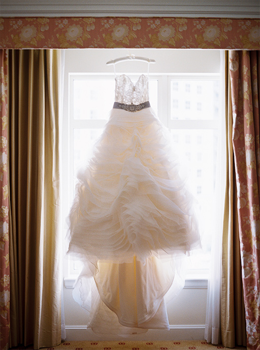 Bridal gown hanging in window