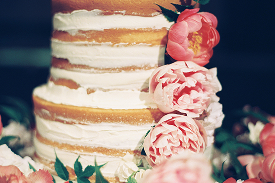 4-tier naked wedding cake detail with smeared buttercream and pink and peach fresh floral by Sugar Bee Sweets
