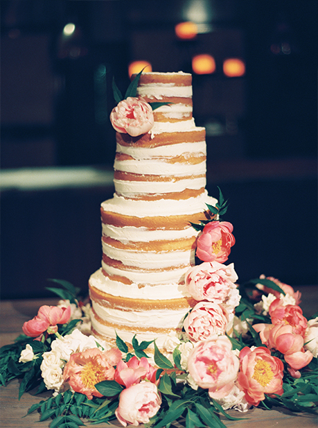 4-tier naked wedding cake with smeared buttercream and pink and peach fresh floral by Sugar Bee Sweets
